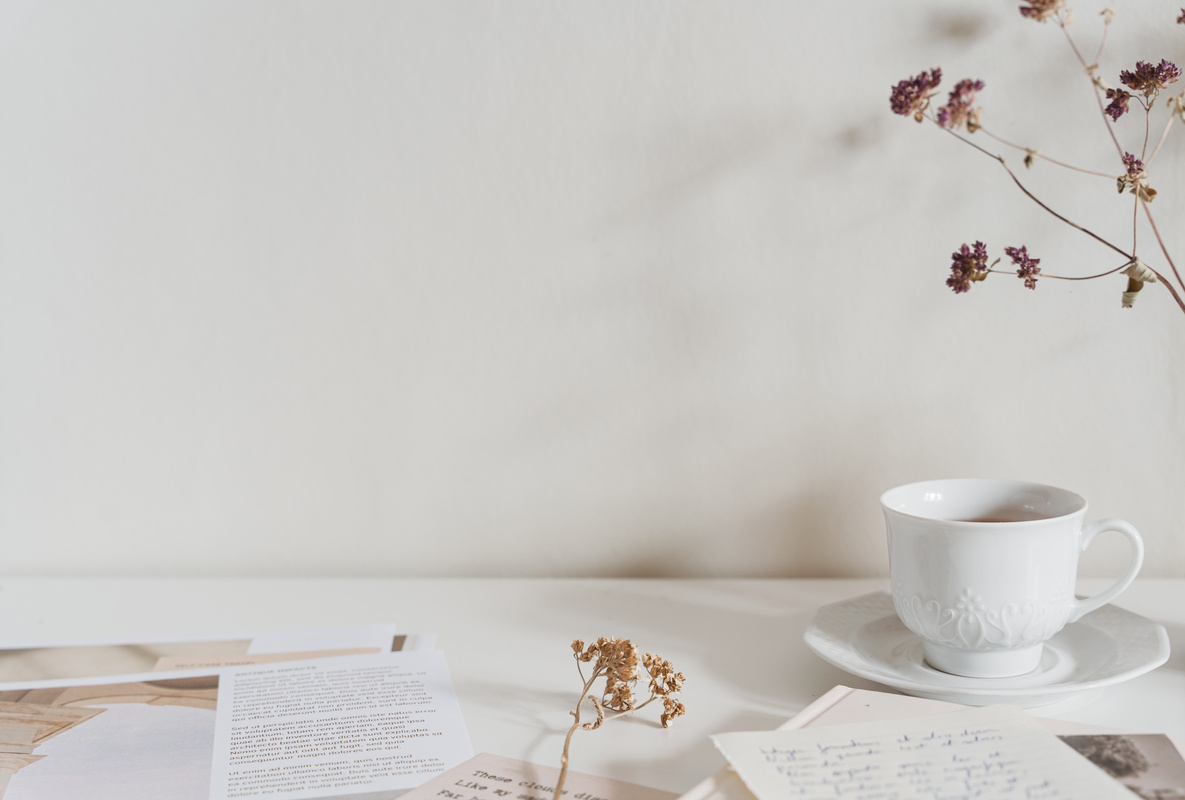 White and beige office desk top background with papers and coffee
